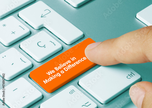 We Believe in Making a Difference - Inscription on Orange Keyboard Key.