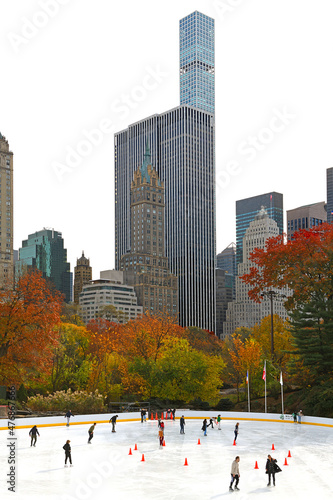 Wollman  ice skating rink in Central Park against backdrop of skyscrapers on late autumn. New York City