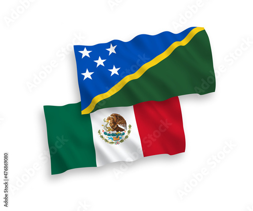 National vector fabric wave flags of Mexico and Solomon Islands isolated on white background. 1 to 2 proportion.