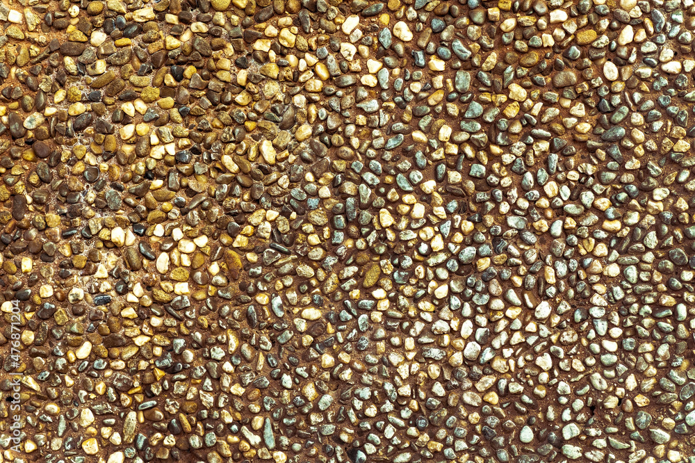 texture with multi-colored stones. objects of different colors on a green background. multicolored pebbles texture with multi-colored stones. objects of different colors on a green background. multicolored pebbles