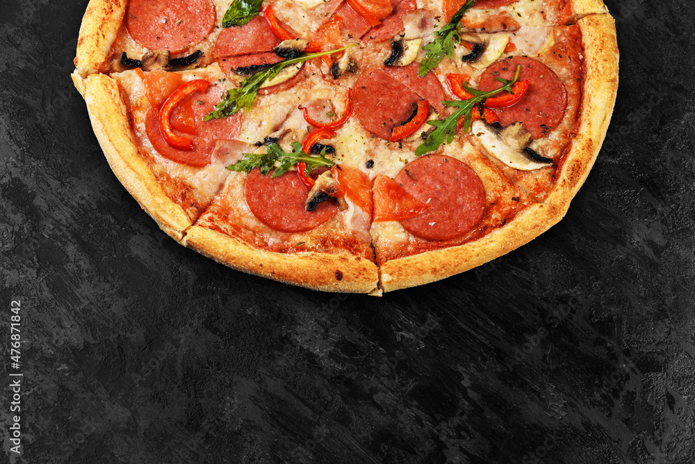 Tasty pizza on black concrete background. Top view of hot pizza. With copy space for text. Flat lay. Banner.