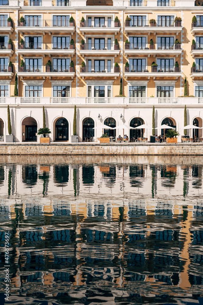 Reflection of the Regent Hotel in the water. Porto, Montenegro