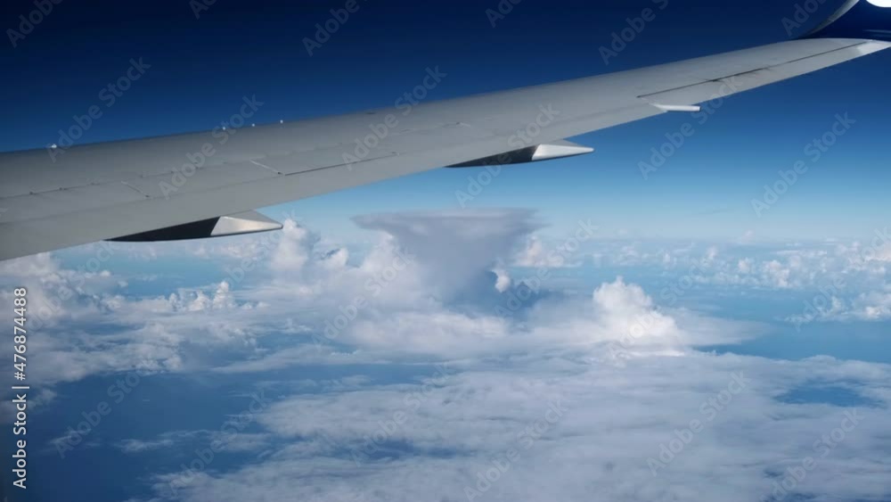 Airplane flight. Wing of an airplane flying above the clouds with sunset sky. View from the window of the plane. Airplane, Aircraft. Traveling by air. Airplane flight. Wing of an airplane flying above the clouds with sunset sky. View from the window of the plane. Airplane, Aircraft. Traveling by air.