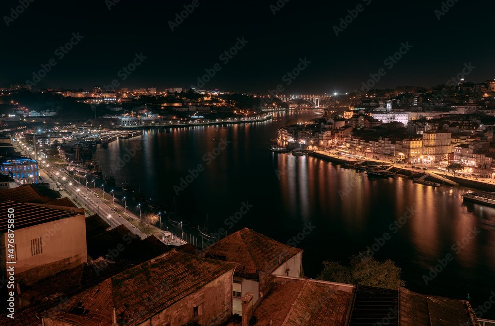Night view over Porto, taken from the iconic bridge spanning over the beautiful city located in Portugal.