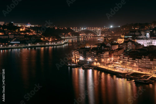 Night view over Porto, taken from the iconic bridge spanning over the beautiful city located in Portugal.
