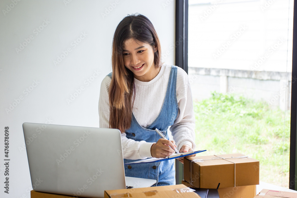 Online business owner checking customer name and address ordering company products, Cropped image of woman checking customer address online for delivery at online sales office. Online business owner checking customer name and address ordering company products, Cropped image of woman checking customer address online for delivery at online sales office.