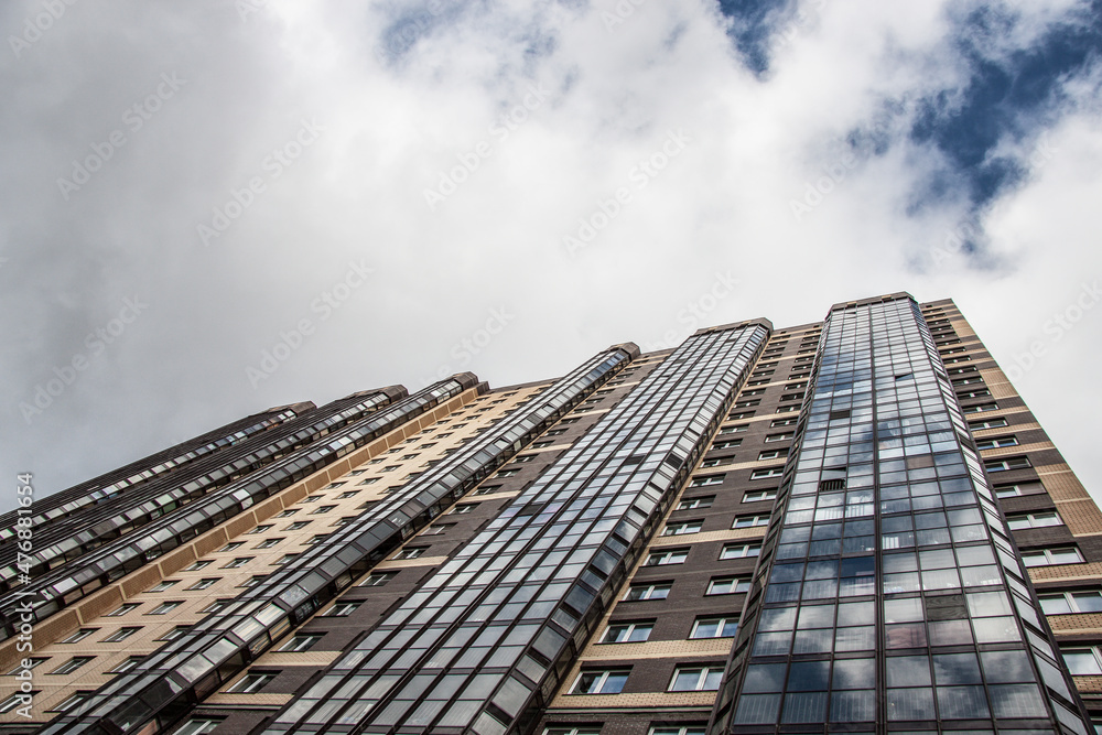 residential building against the background of clouds close-up residential building against the background of clouds close-up
