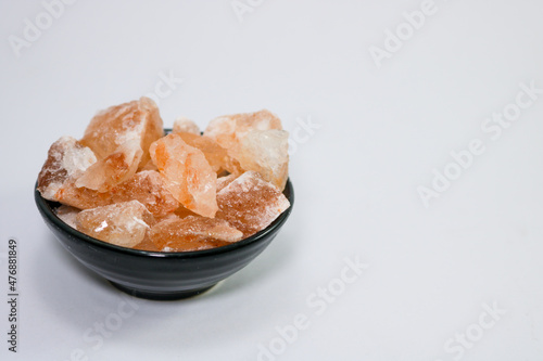 Pink salt on isolated white background with copy space.