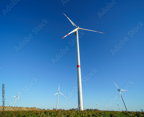 Green meadow with wind turbines for power generation