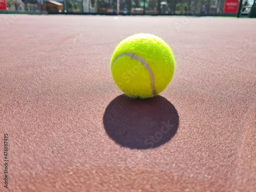 Tennis ball on the sunny red hard  © ILLyas IDOL