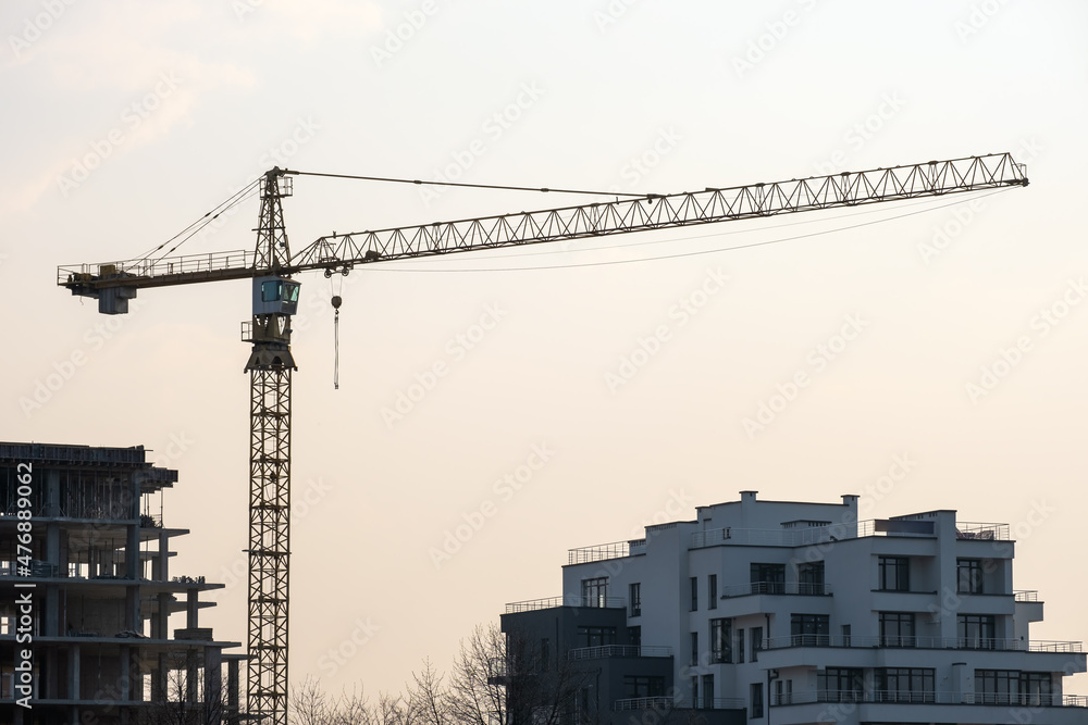 Tower cranes and high residential apartment buildings under construction. Real estate development Tower cranes and high residential apartment buildings under construction. Real estate development