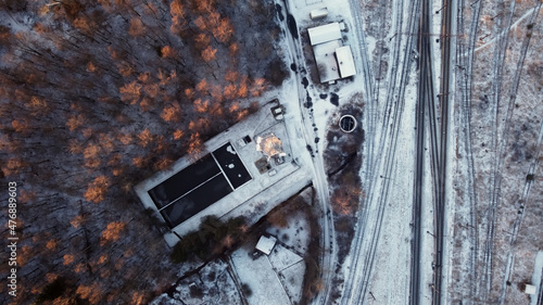 Air view on the sewage treatment plant and communication tower. during the winter. View from the top down.