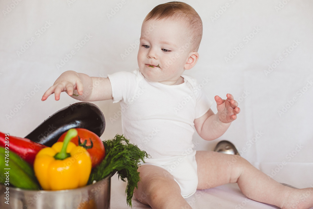 Healthy nutrition Happy baby boy in hat prepares a vegetable salad. Cook Healthy nutrition Happy baby boy in hat prepares a vegetable salad. Cook
