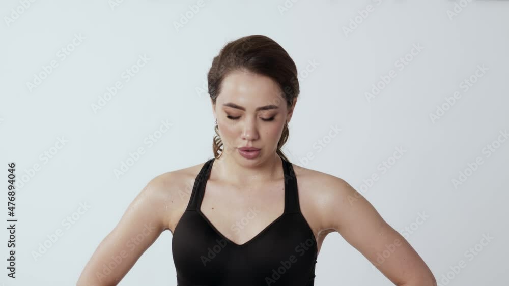 Portrait of a tired brunette woman relaxing in a short break after a workout and motivating herself to do sports 4K Portrait of a tired brunette woman relaxing in a short break after a workout and motivating herself to do sports 4K
