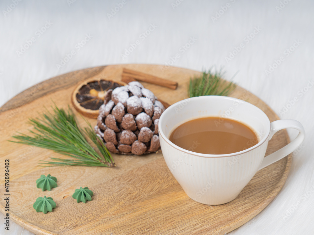 Sweet chocolate dessert in the shape of a cone on a wooden tray. on white background. Christmas treat..There is room for text. Sweet chocolate dessert in the shape of a cone on a wooden tray. on white background. Christmas treat..There is room for text.