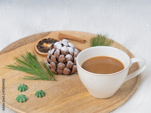 Sweet chocolate dessert in the shape of a cone on a wooden tray. on white background. Christmas treat..There is room for text.