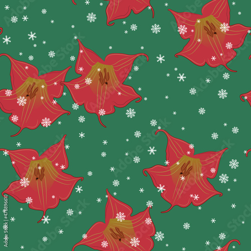 Seamless floral pattern with flowers of red datura and snowflakes. Brugmansia sanguinea. On green background. Seasonal winter design.