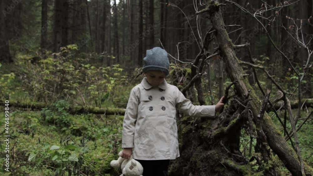 Little girl with teddy bear alone in a forest Little girl with teddy bear alone in a forest