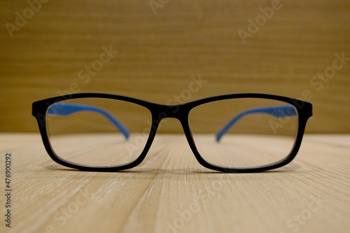 Close up of eyeglasses on brown wooden background, for Myopia (nearsightedness) or presbyopia (farsightedness)