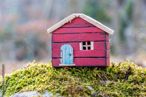 red color wooden model house in the wood