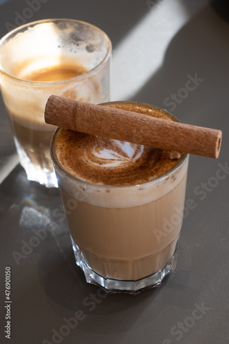 Cinnamon macchiato in a glass beaker in the cafe
