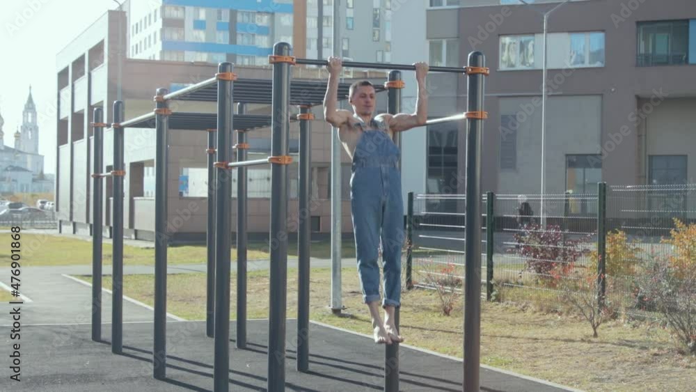 A man exercising on a sports ground A man exercising on a sports ground