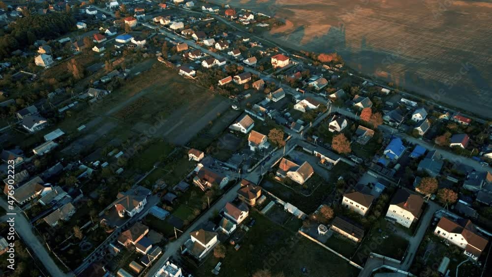 Country houses in the countryside. Aerial view of roofs of green field ...