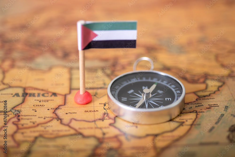 Flag of Sudan and compass on the world map. Flag of Sudan and compass on the world map.