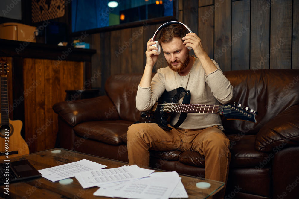 Obraz premium Man taking off headphones finish music lesson