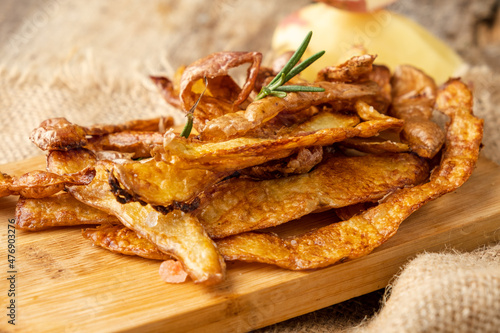 Crispy potato peel chips with rosemary and salt close-up. Sustainable food.