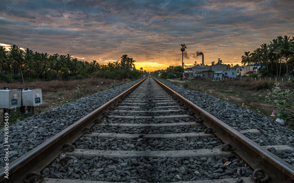 Sunrise on a Railway track against sunny sky beautiful clouds.