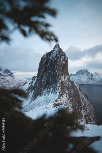 Mountain resembling a frosty rocky tooth on the Senja peninsula called Segla in northern Norway. A tourist attraction near the village of Fjordgard. Landscape beyond the Arctic Circle. Scandinavia photo