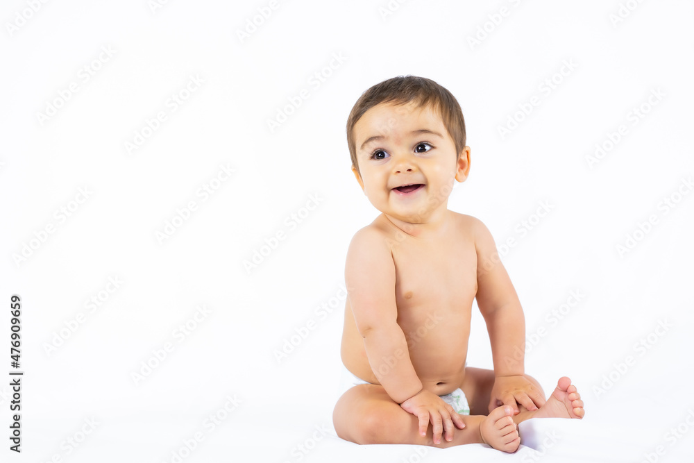 Baby boy in a studio with a white background, newborn caucasian eight months old smiling Baby boy in a studio with a white background, newborn caucasian eight months old smiling
