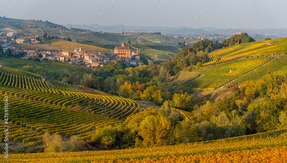 Beautiful hills and vineyards during fall season surrounding Barolo village. In the Langhe region, Cuneo, Piedmont, Italy.