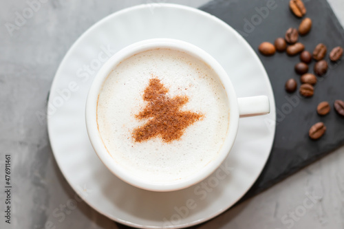 cappuccino coffee cup with cinnamon pattern, christmas drink,on concrete background