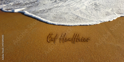 Eat healthier sand lettering new year resolution text photo