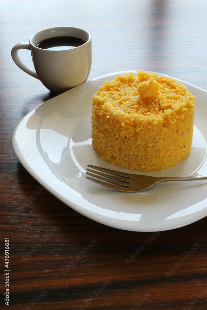 Couscous with butter on top with cup of black coffee on the backlight. Couscous with butter on top with cup of black coffee on the backlight.