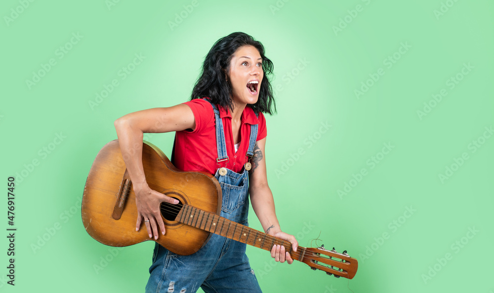 Let the Music Speak. music concept. Singing Songs. talented musician. Lifestyle and People Concept. playing the guitar. play on string instrument. having a party. Happy woman with acoustic guitar Let the Music Speak. music concept. Singing Songs. talented musician. Lifestyle and People Concept. playing the guitar. play on string instrument. having a party. Happy woman with acoustic guitar