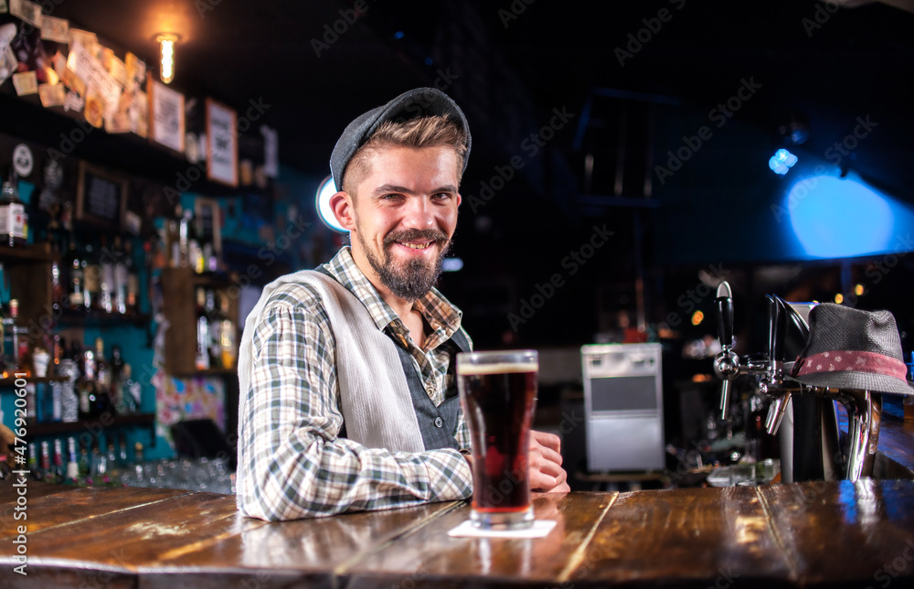 Experienced bartender is pouring a drink at the nightclub