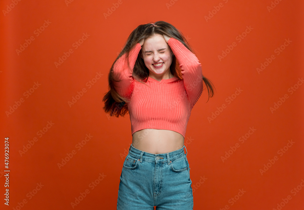 Happy young girl burying hands to long shiny strong hair, enjoying result of beauty haircare products use Happy young girl burying hands to long shiny strong hair, enjoying result of beauty haircare products use