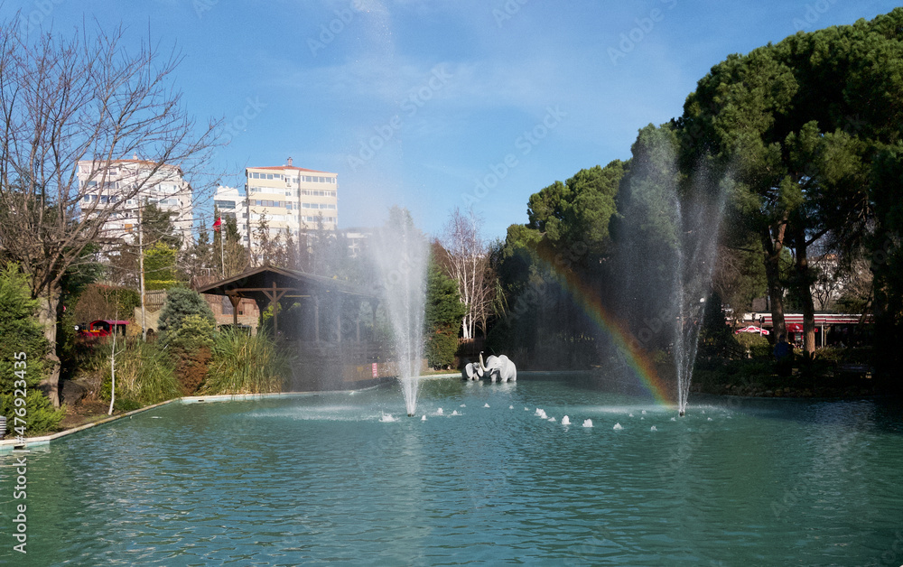 fountain creates rainbow in the park