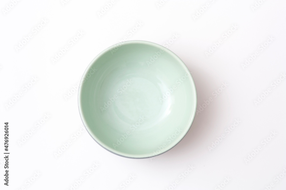 Empty green bowl isolated on white background. Top view. Empty green bowl isolated on white background. Top view.
