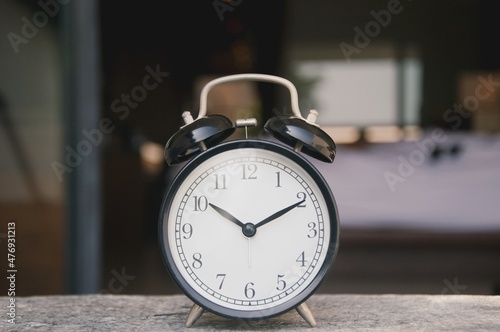 Retro alarm clock on table in living room with furniture background , object for interior decoration 