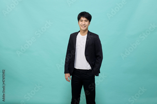 Handsome Asian man in a black suit looking at camera