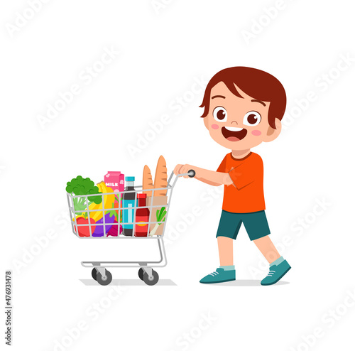 cute little boy push shopping cart full of groceries