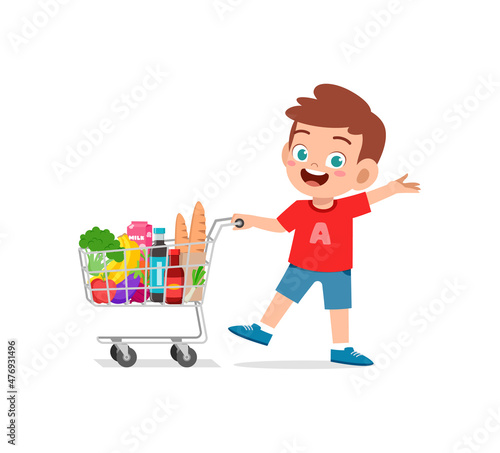 cute little boy push shopping cart full of groceries