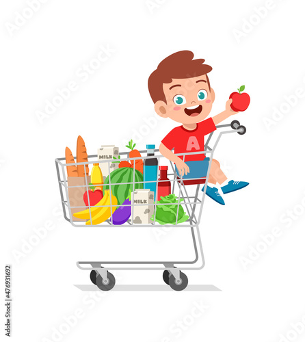 cute little boy sit on shopping cart