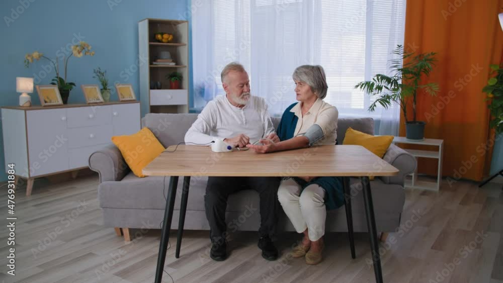 measurement of pressure and pulse at home, grandparents take care of health, elderly couple uses tonometer measurement of pressure and pulse at home, grandparents take care of health, elderly couple uses tonometer