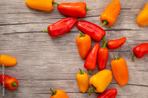 Red and yellow peppers on wood background. Flat lay of peppers.