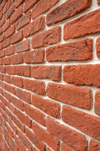 Clinker brick of red color. Tiles for the exterior of the facade of the house. Textured surface pattern for design or backdrop.